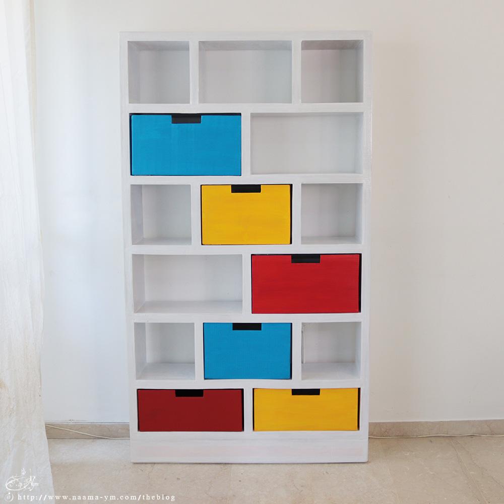 white shelving unit with boxes